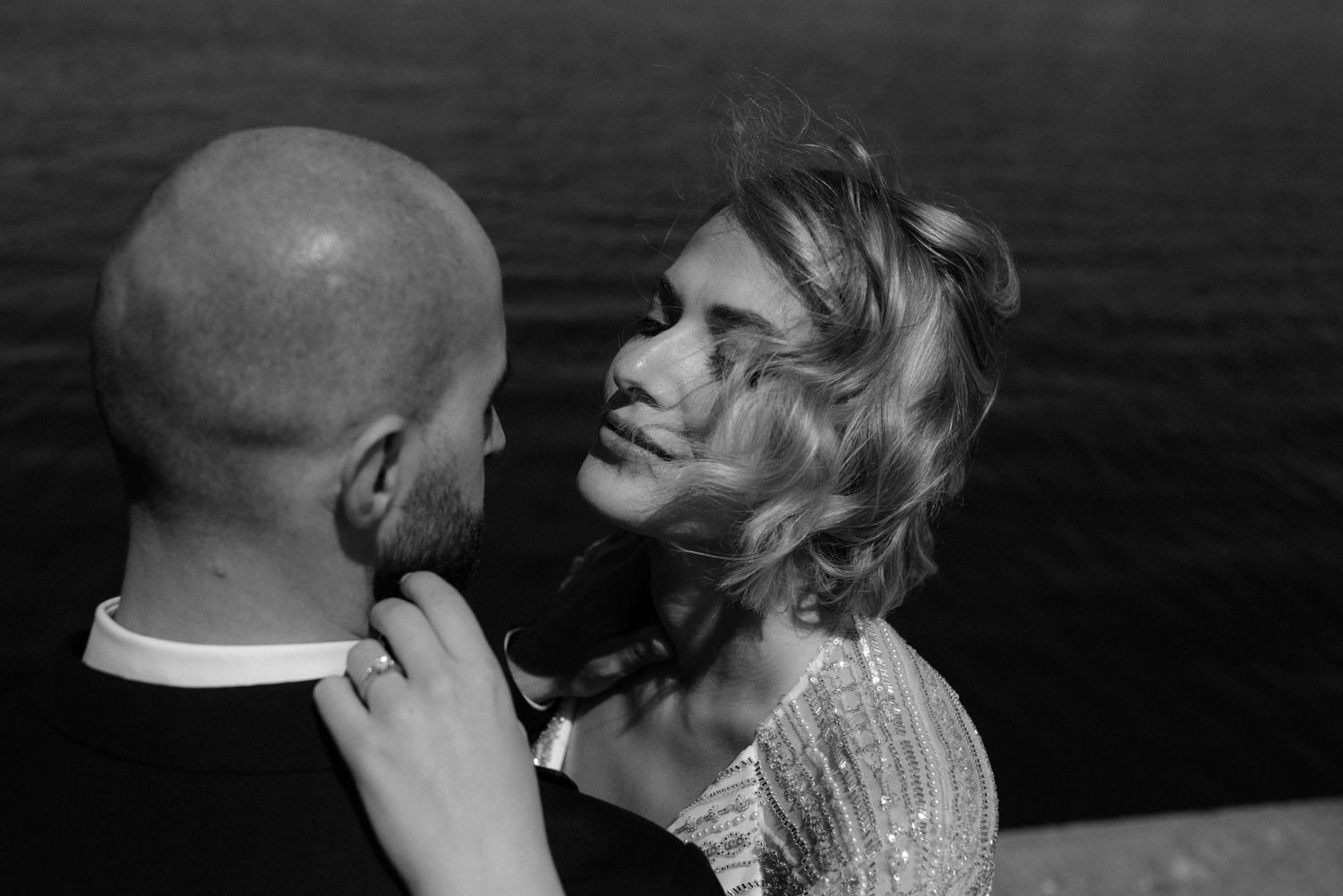 A series of black and white romantic wedding photographs showing intimate moments between a couple at their celebration.