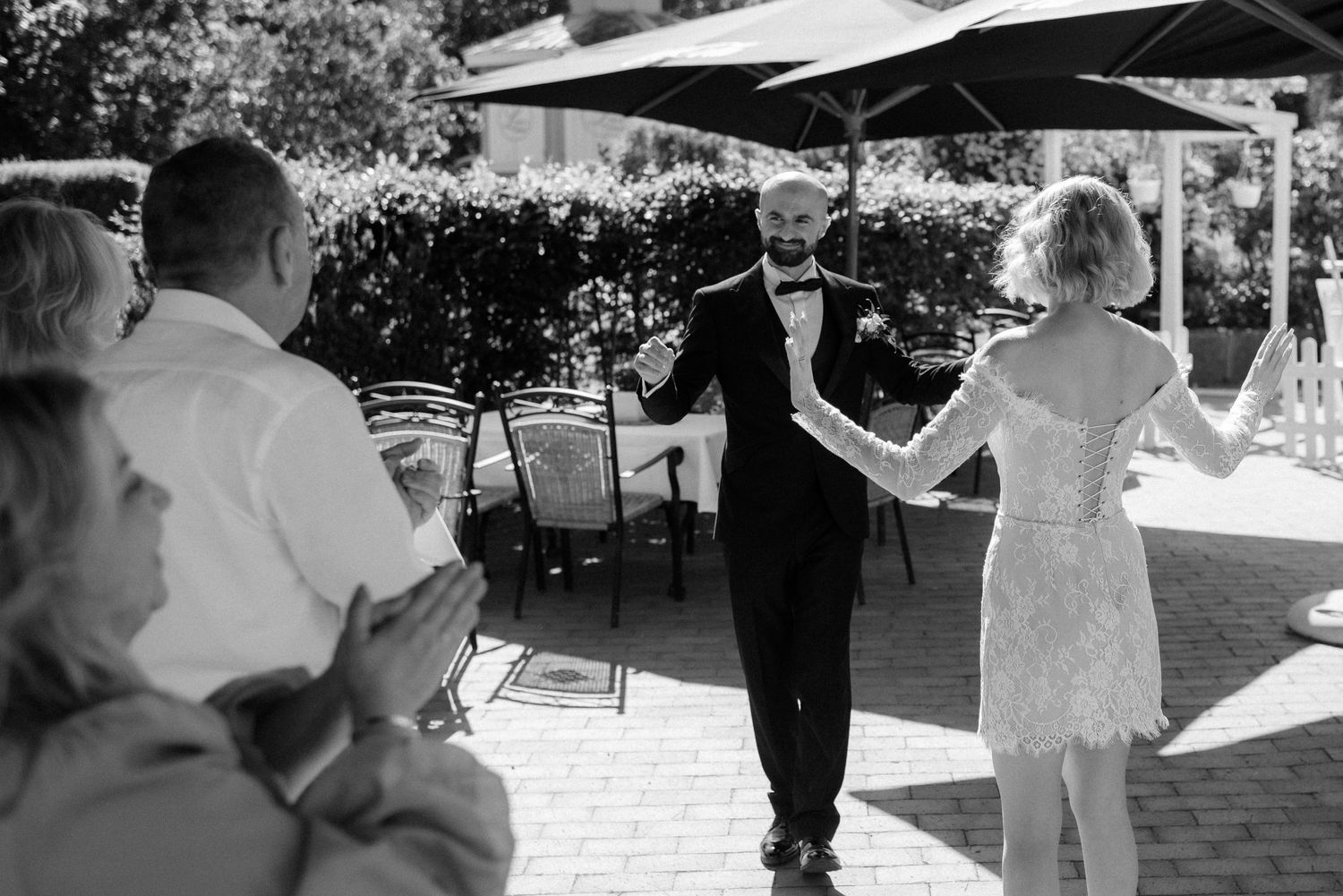 A black and white collage strip showing multiple people dancing at what appears to be an outdoor celebration or party.