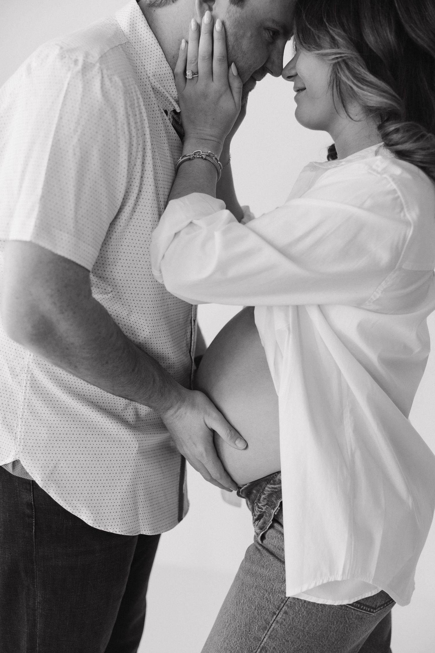 Intimate dance sequence in white clothing shown in series of close-up shots against light background.