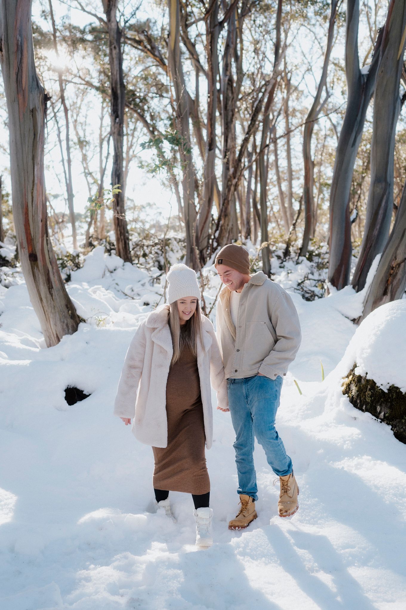 A series of four photos showing people playing and having fun in a snowy winter forest setting.