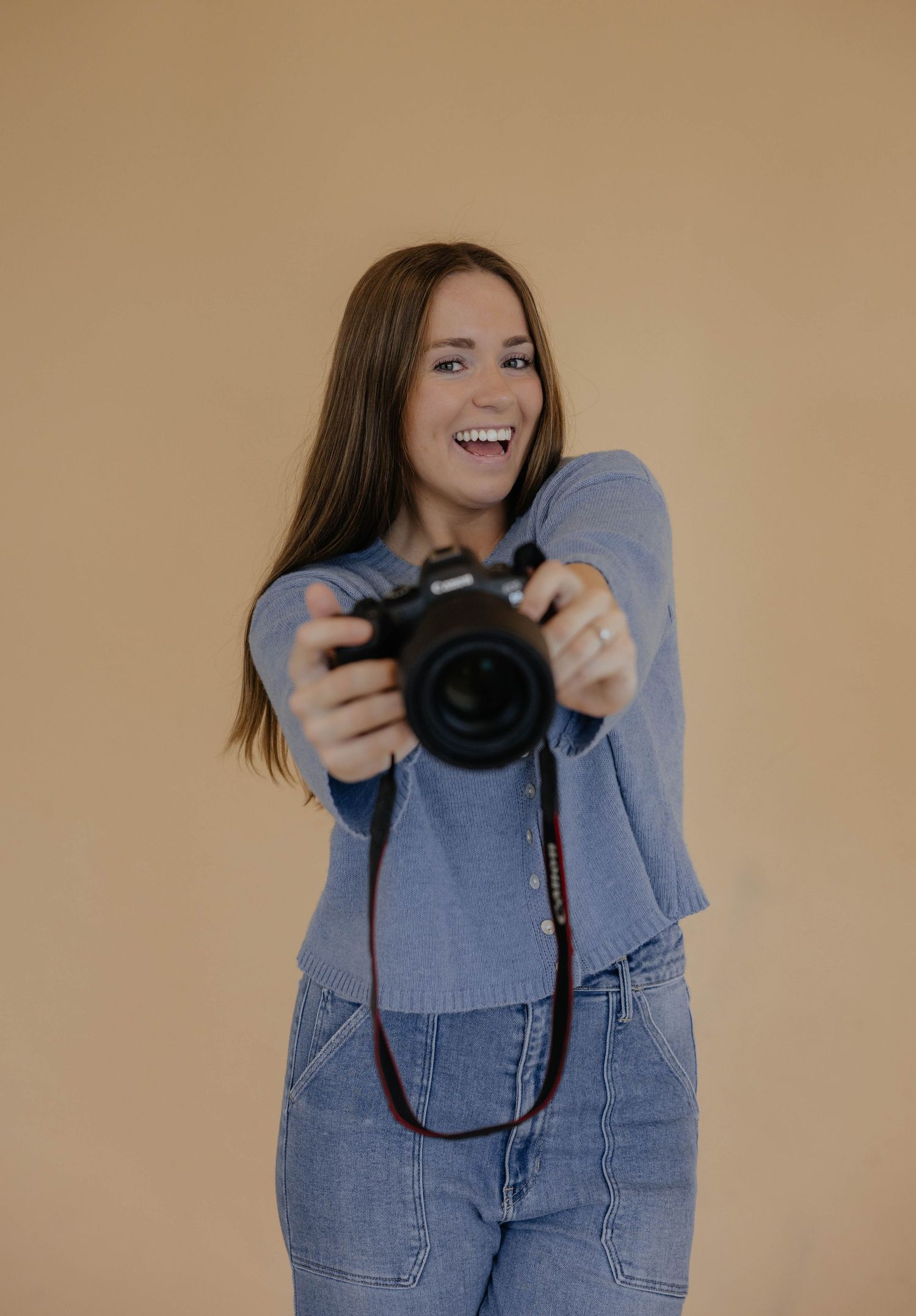 A photographer in blue denim holds up a professional camera with joyful expressions in a photoshoot progression.