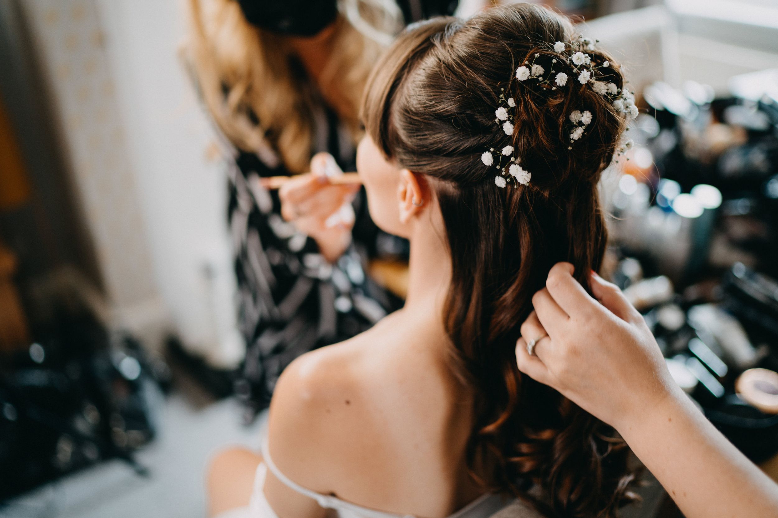 Close-up of elegant bridal hairstyle with delicate floral accessories.