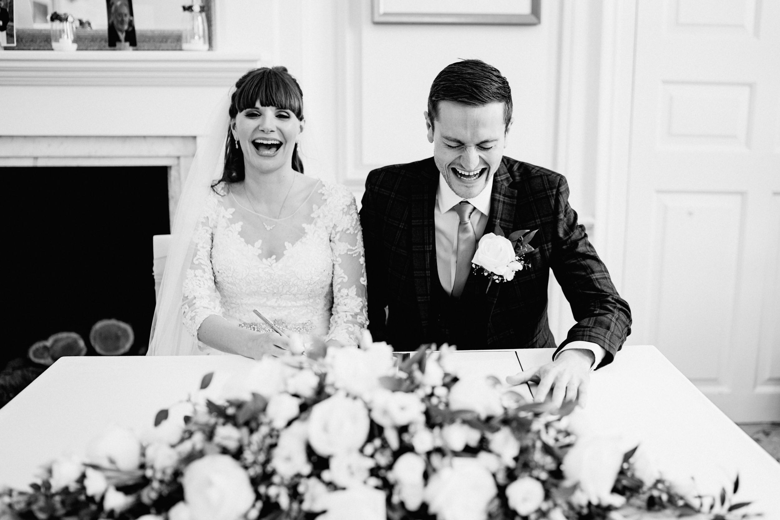 Black and white photo of joyful moment during wedding ceremony.