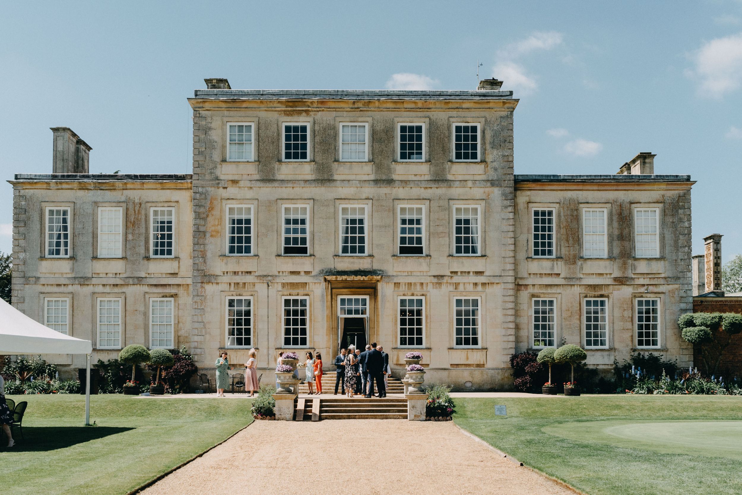 Harrowden Hall elegant Georgian manor house wedding venue with manicured lawn and gravel driveway.