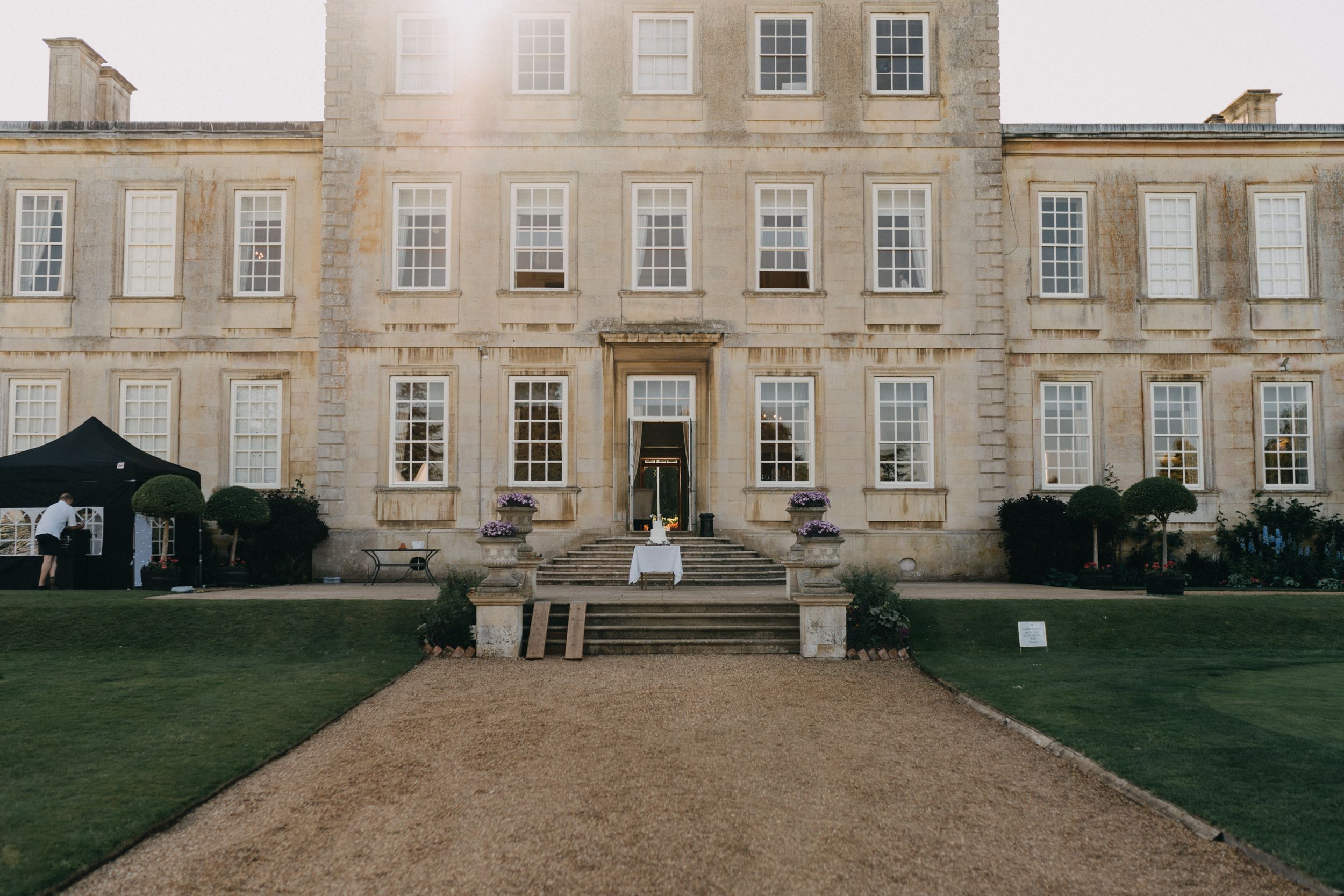 A grand Georgian style mansion with symmetrical windows and manicured grounds.