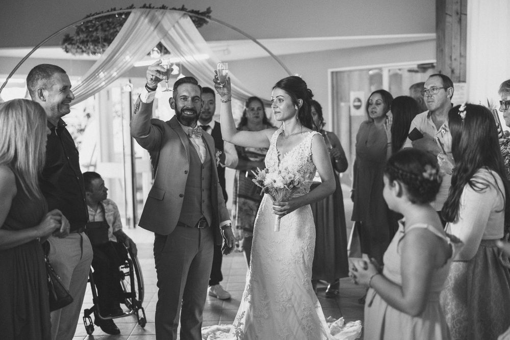 Wedding guests celebrating and dancing at an indoor reception.