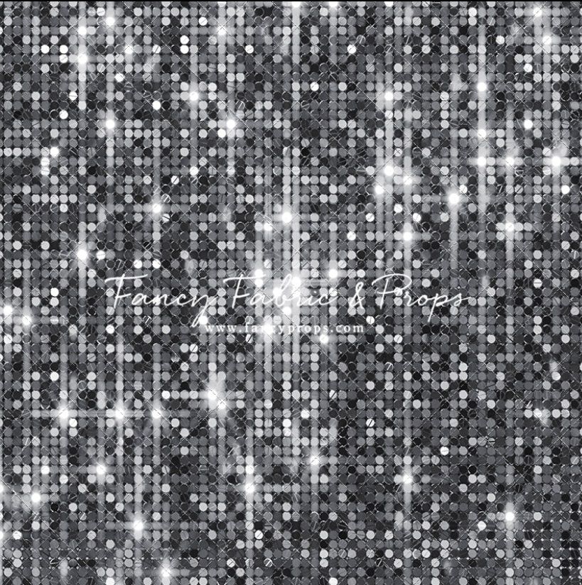Glittering stars sparkle against a black background creating a dazzling celestial pattern of white dots and sparkles.