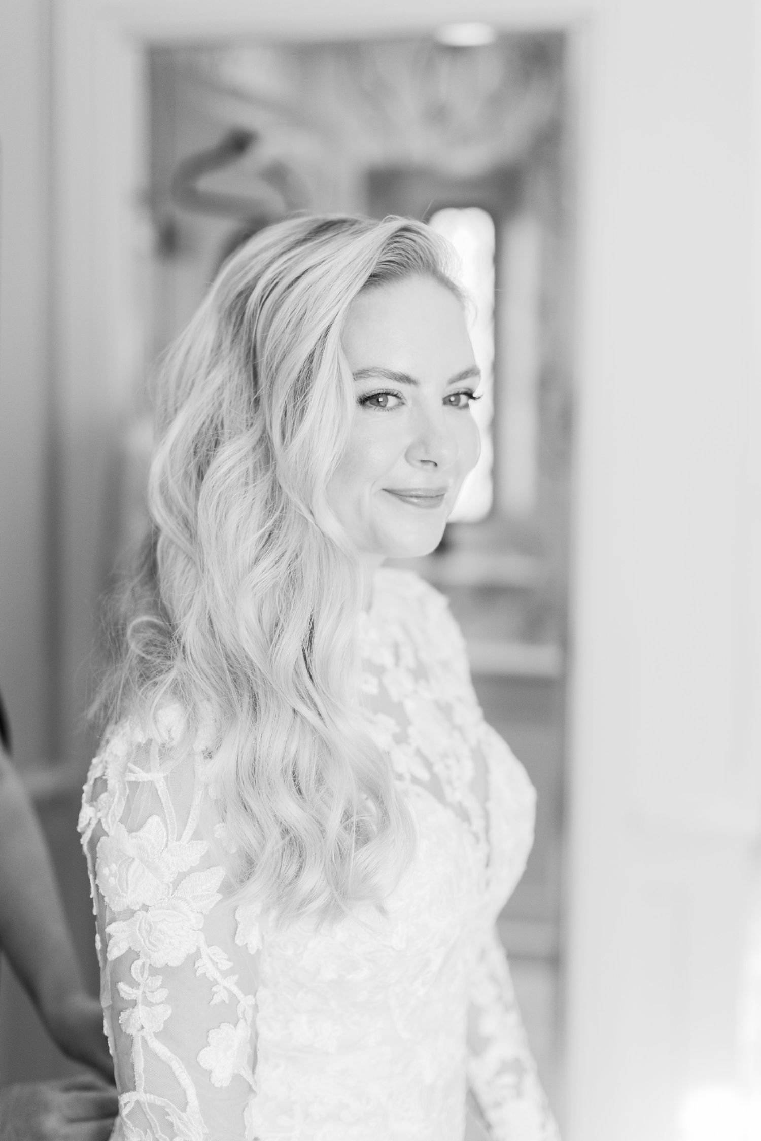 A black and white portrait of bride on her wedding morning at elleborough park in soft lighting dressed in lace dress - cotswolds