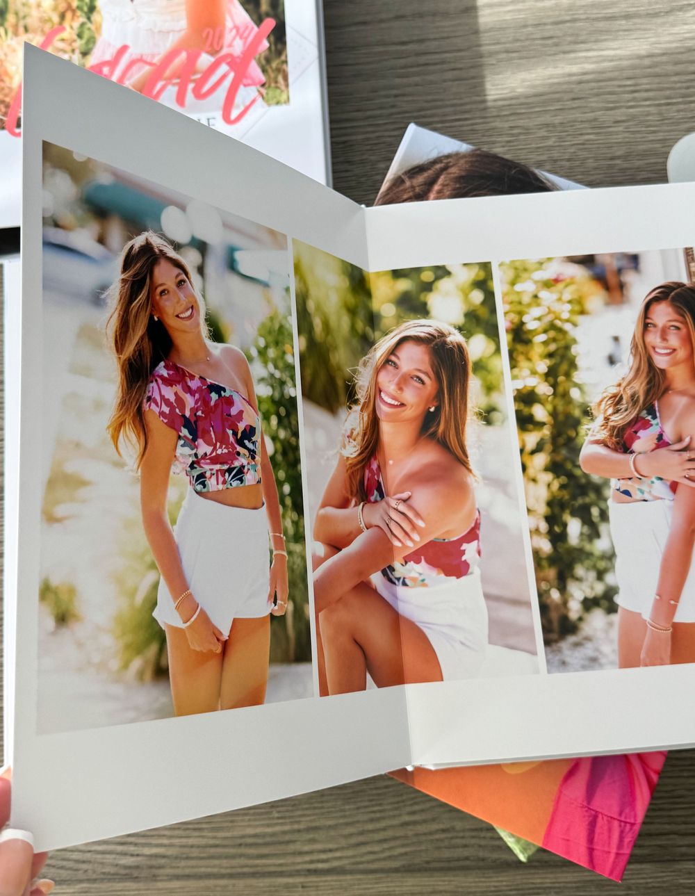 Three overlapping polaroid-style photos laid on a gray surface showing summer fashion portraits in outdoor settings.