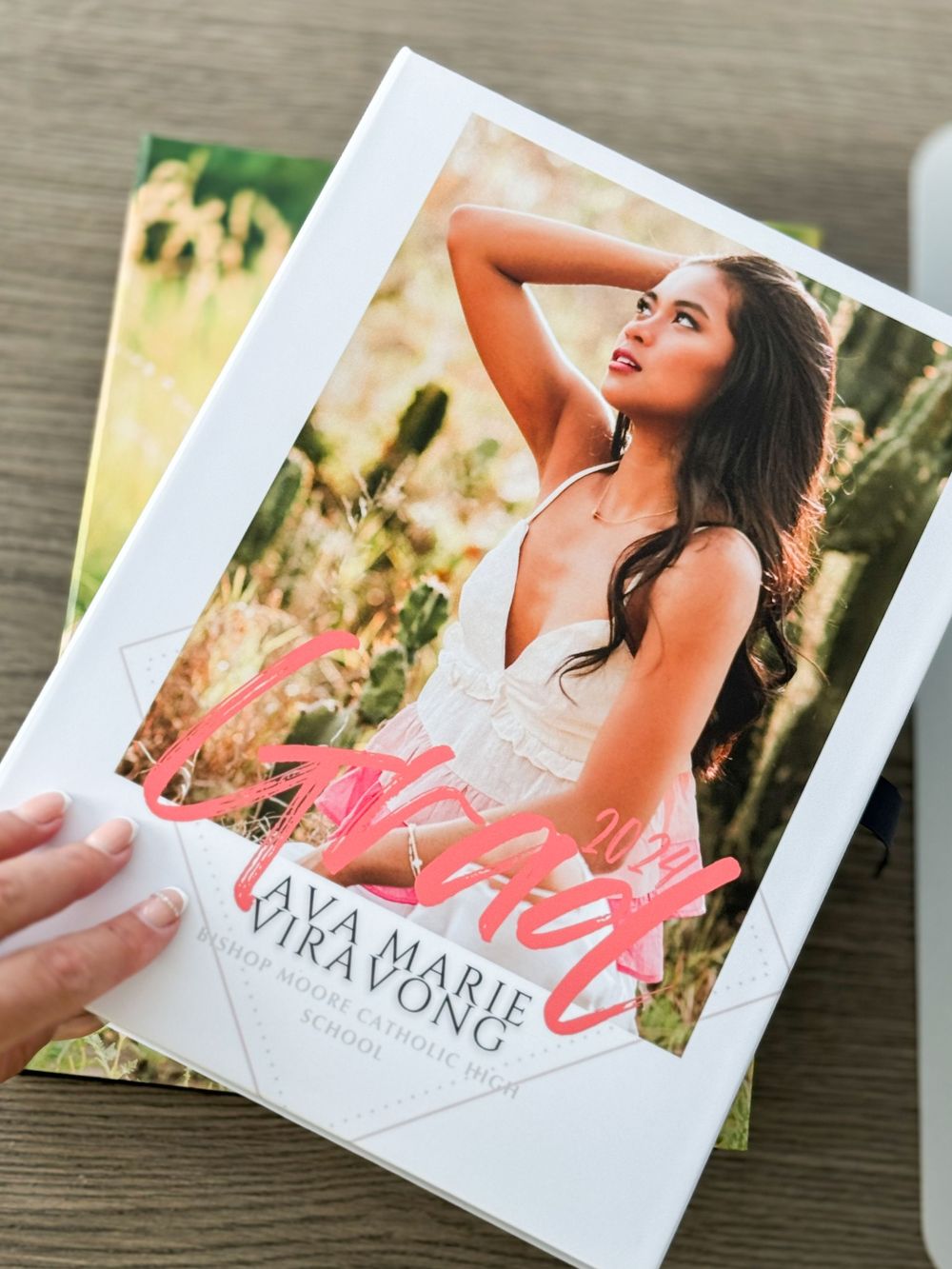 A fashion photography book cover showing a sun-drenched portrait in a natural outdoor setting.