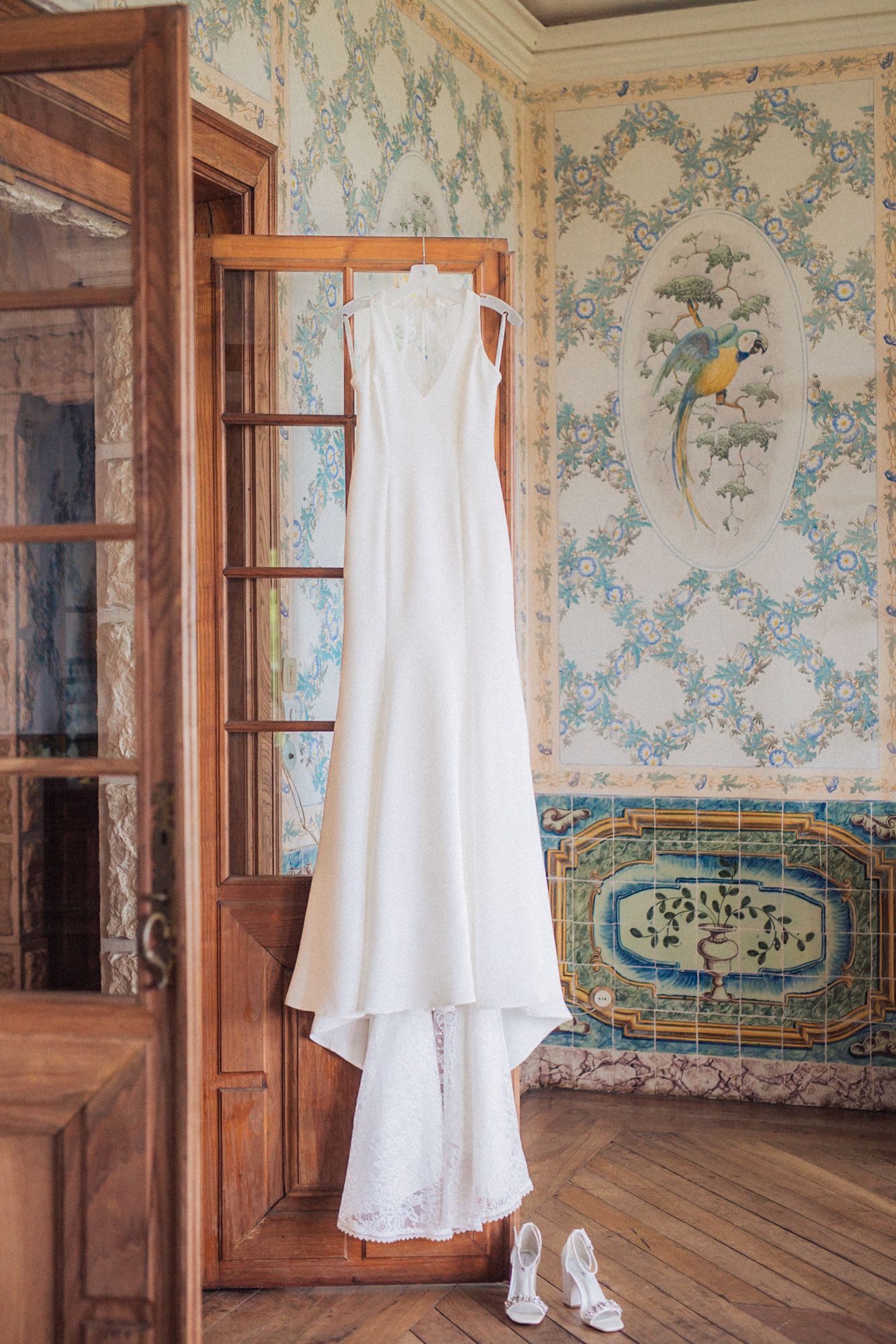 wedding gown displayed in an elegant French-style room at Casa dos Penedos. Captured by a destination wedding photographer in Lisbon