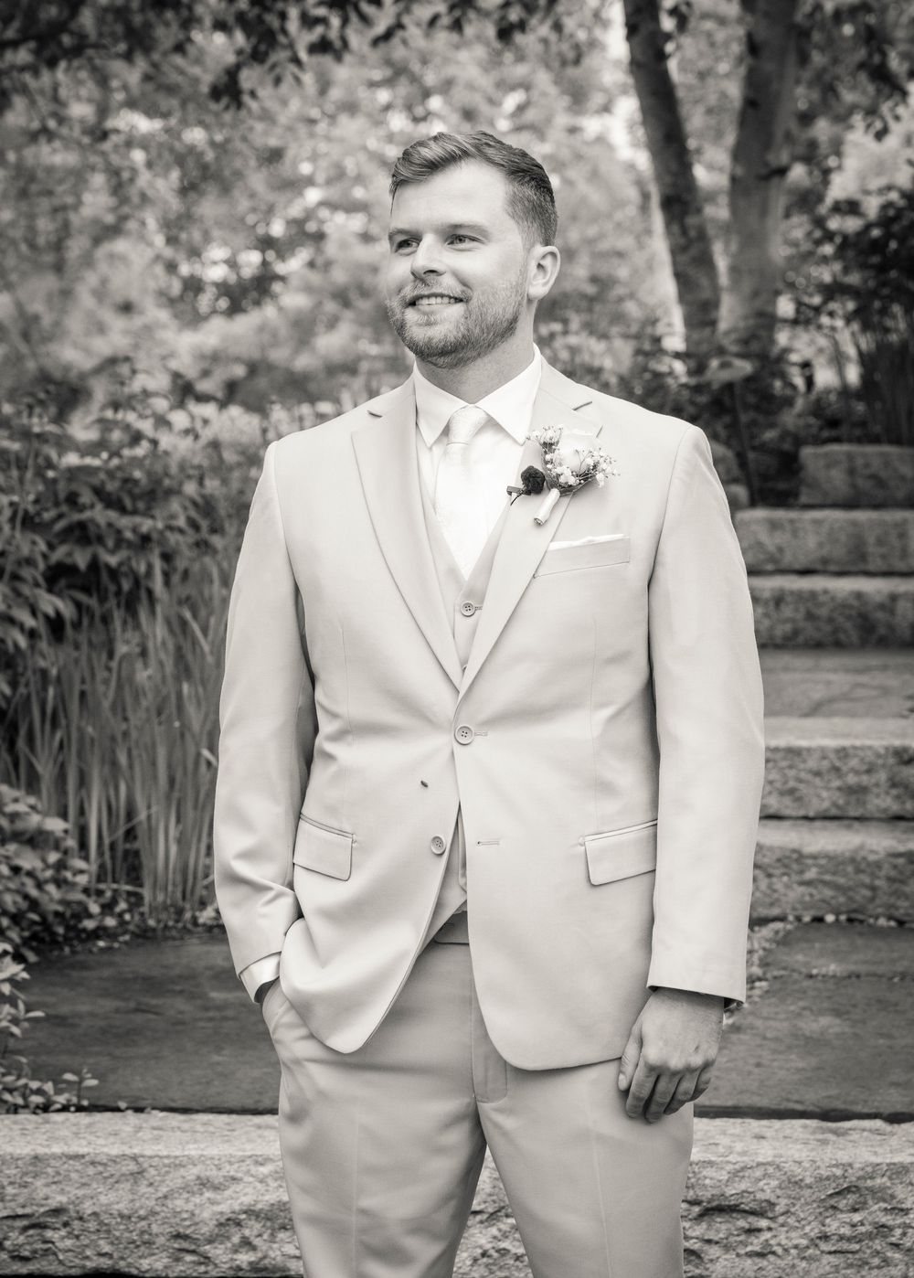 A series of black and white photos showing a person in a light-colored formal suit at an outdoor event.