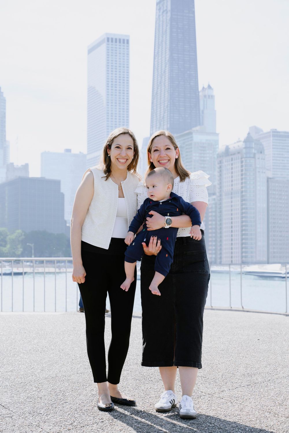 Family photo against Chicago skyline backdrop with iconic skyscrapers and waterfront views.