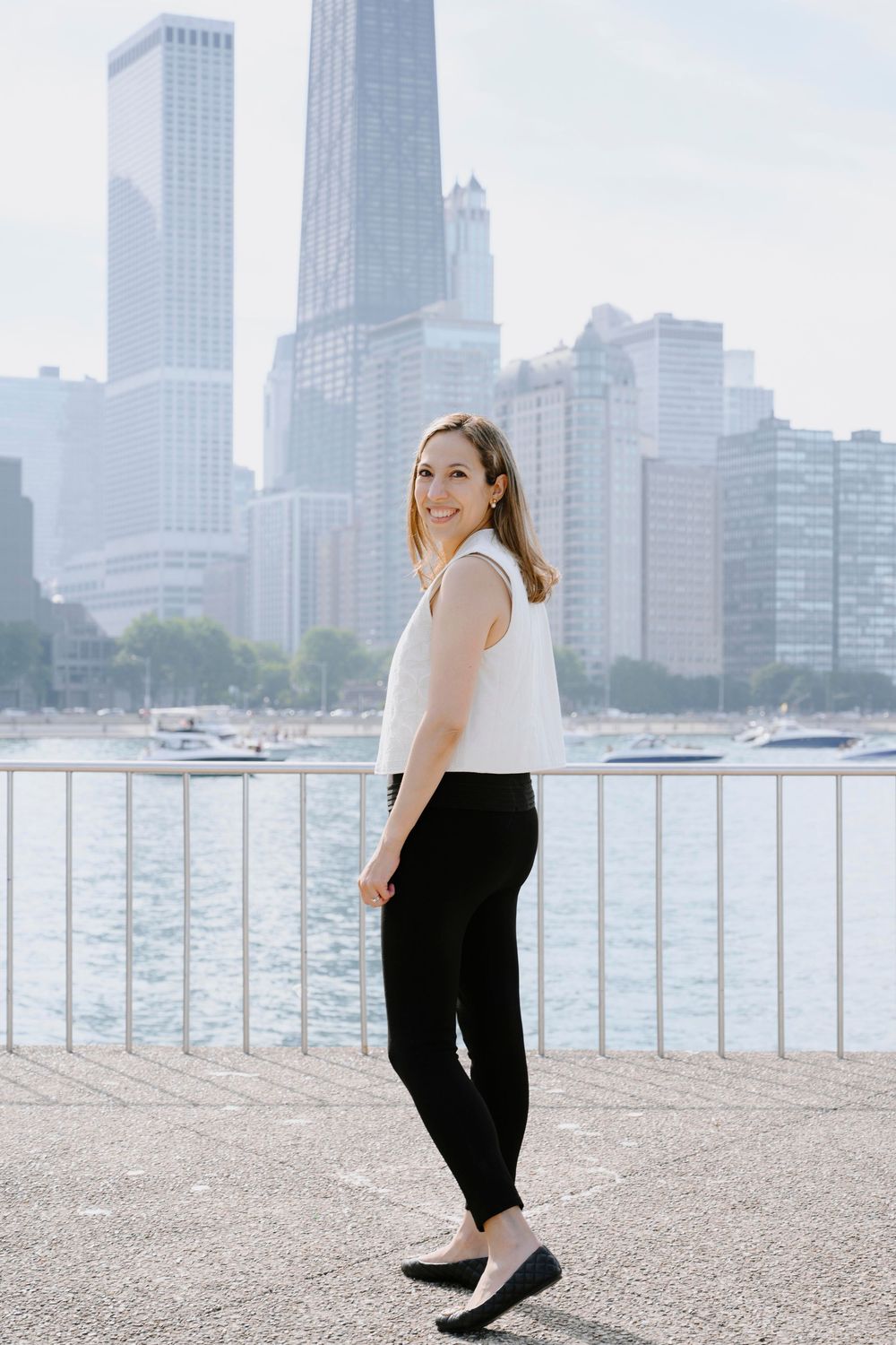 Stylish outfit against Chicago skyline with Lake Michigan waterfront and skyscrapers in background.