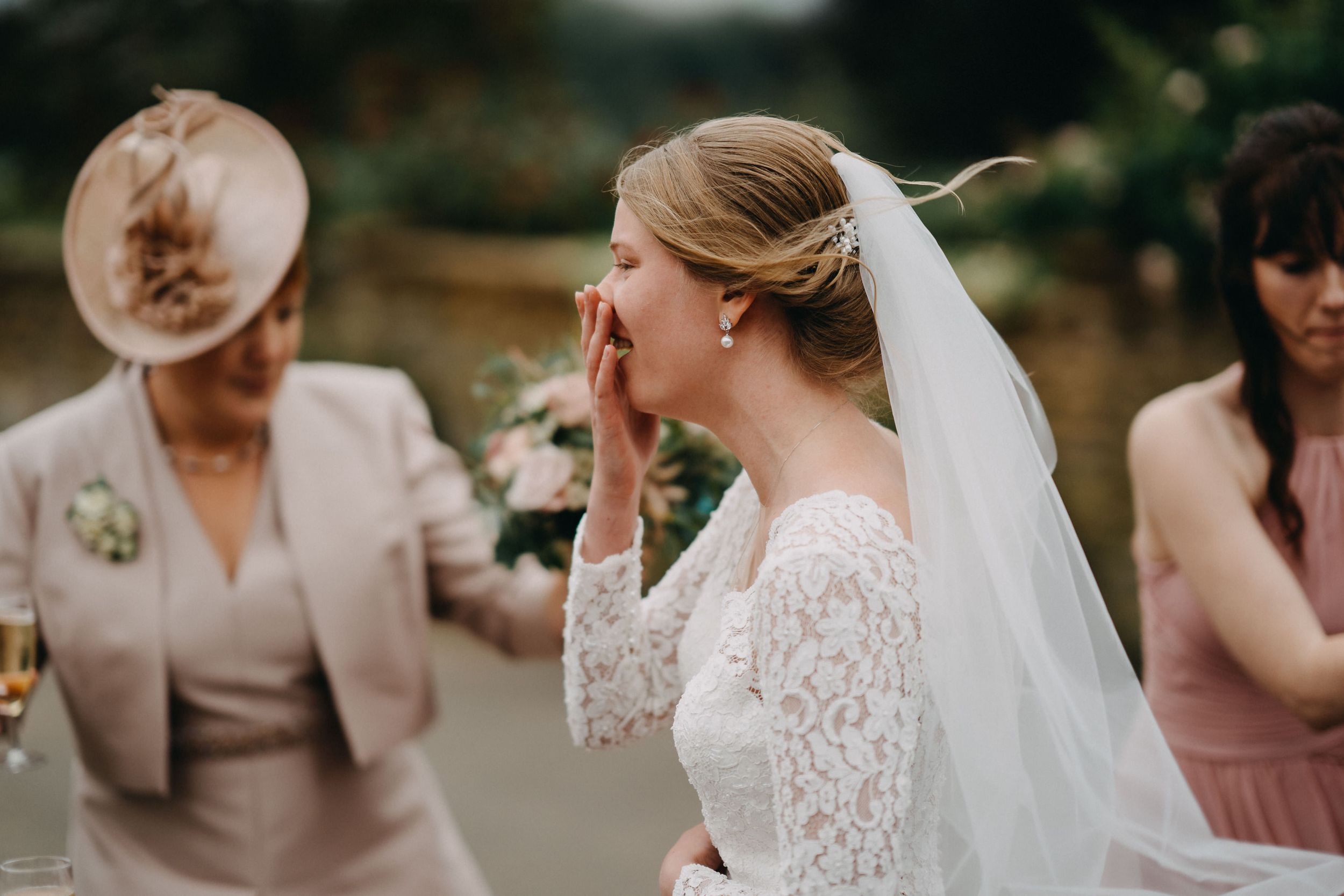 Emotional wedding day moment captured during outdoor celebration.