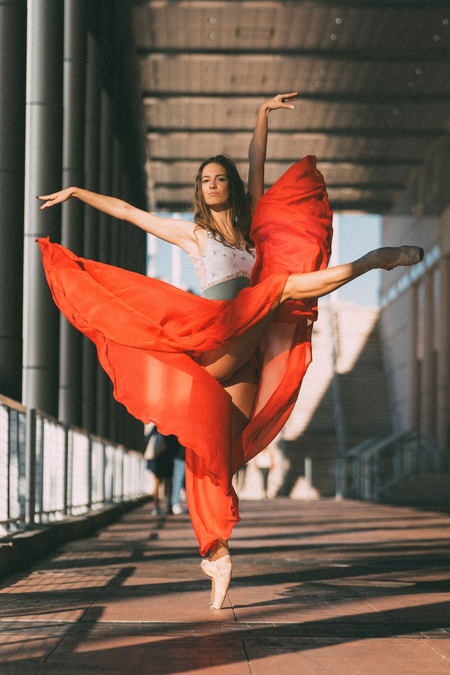 Tampa Dance Photographer capturing a ballerina in bright red skirt pointe shoes and leotard