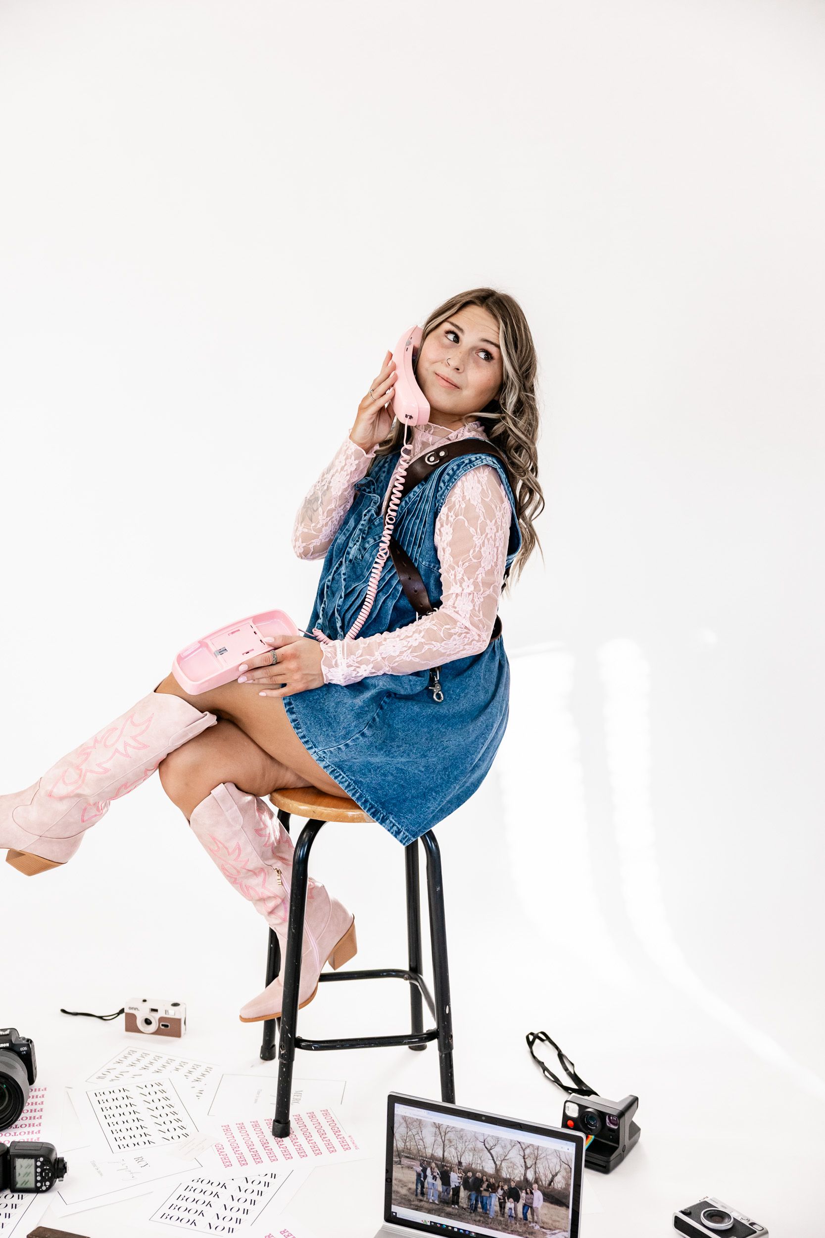 Wyoming Photographer
Stylish outfit featuring denim dress with pink boots and lace top shown in editorial photoshoot setting.