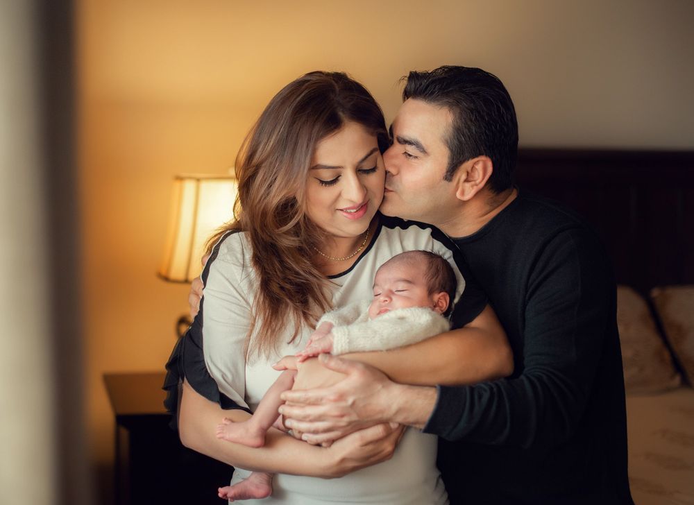 newborn photo session includes family portraits of the parents with the baby