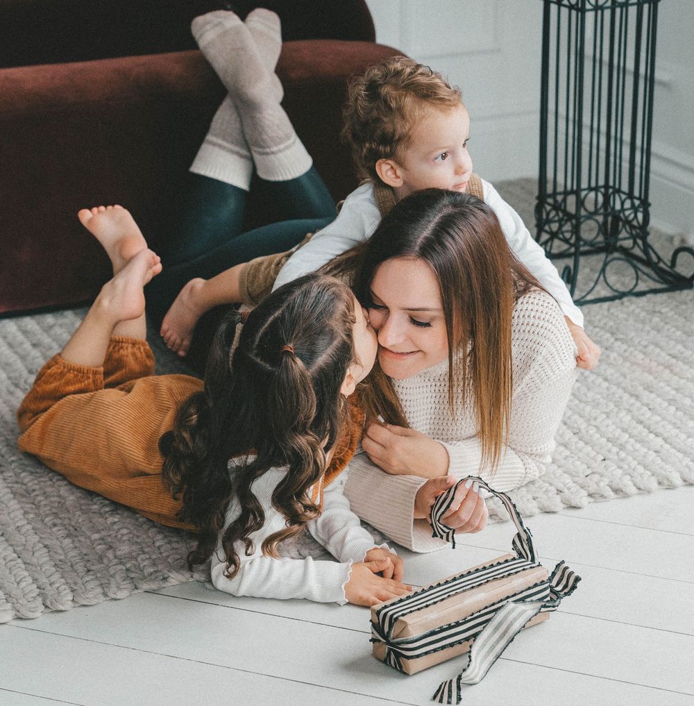 cozy cuddles with the kids during the holiday mini session at Mint Room studio in Toronto
