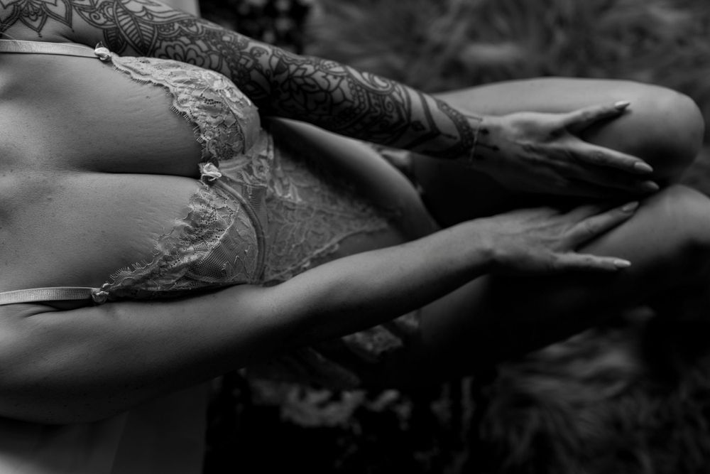 Black and white artistic photo of delicate lace lingerie details.