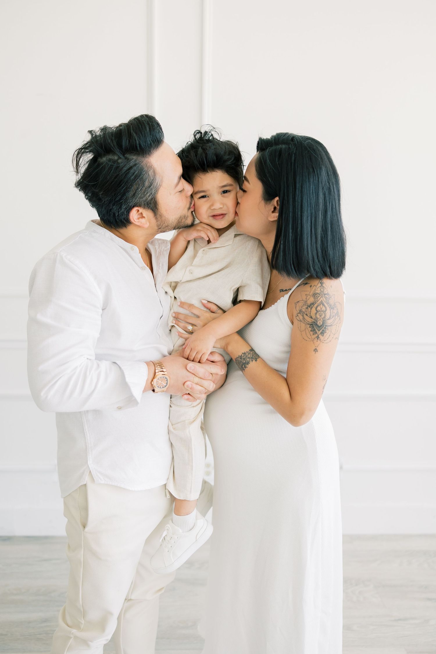 A touching family moment captured against a clean white backdrop.