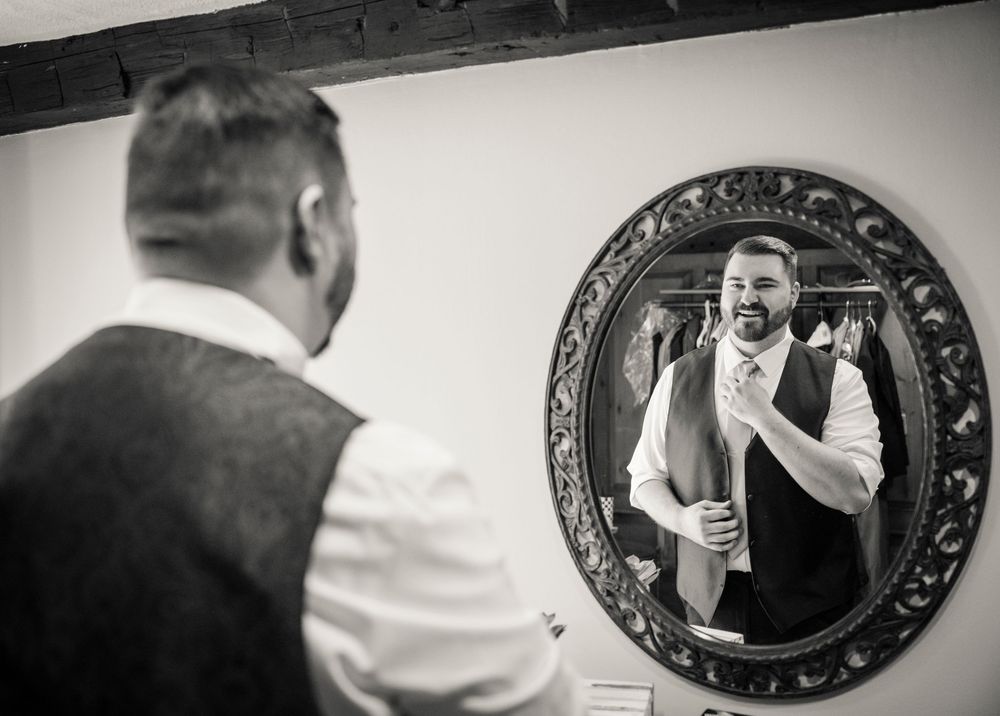 A series of black and white photographs showing people looking into decorative hanging mirrors.
