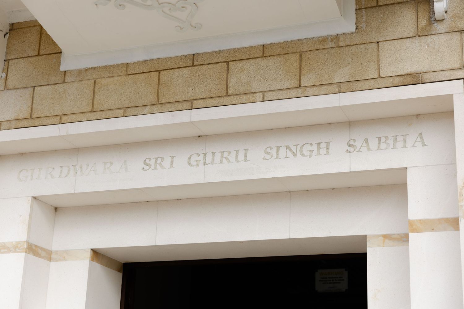 Photo of the lettering of the name of Hounslow Gurdwara, saying: Gurdwara Sri Guru Singh Sabha