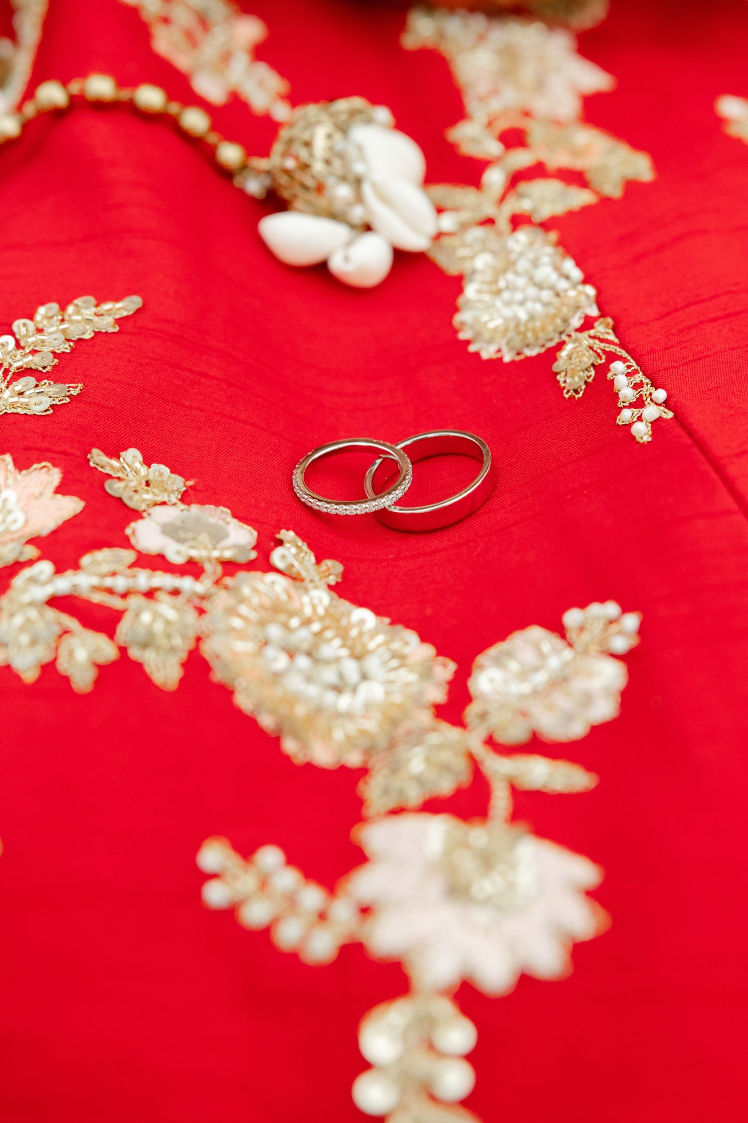 Wedding rings on red lehenga