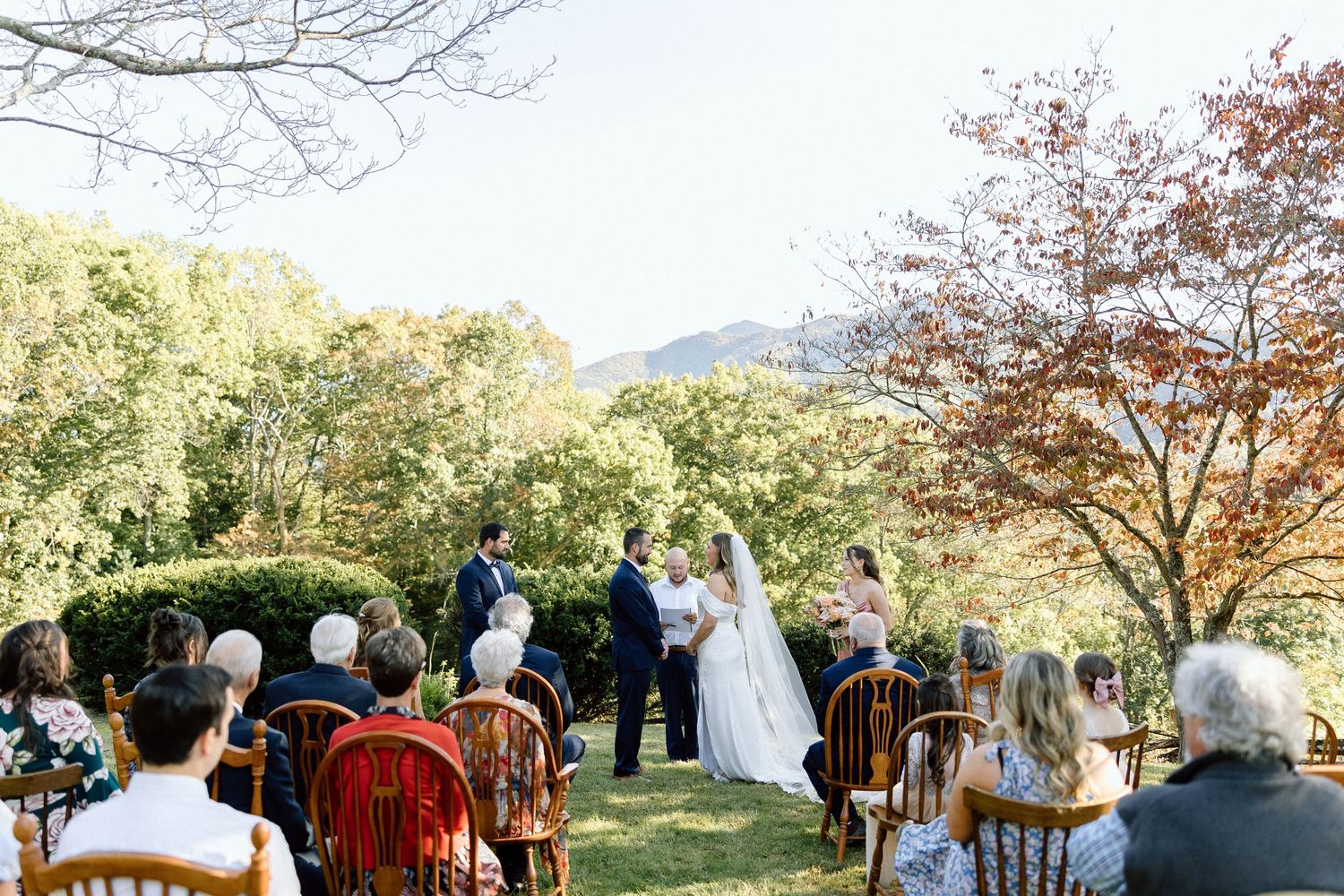 A series of outdoor wedding ceremony photos showing guests and wedding party gathered under autumn trees.