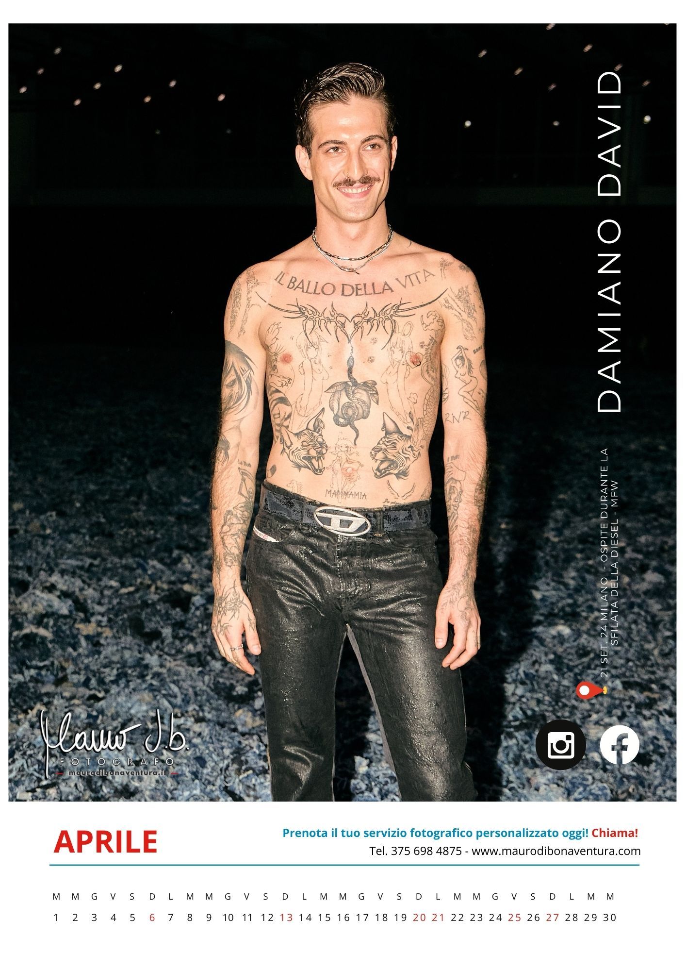Shirtless model with tattoos wearing black leather pants against dark background for April calendar.