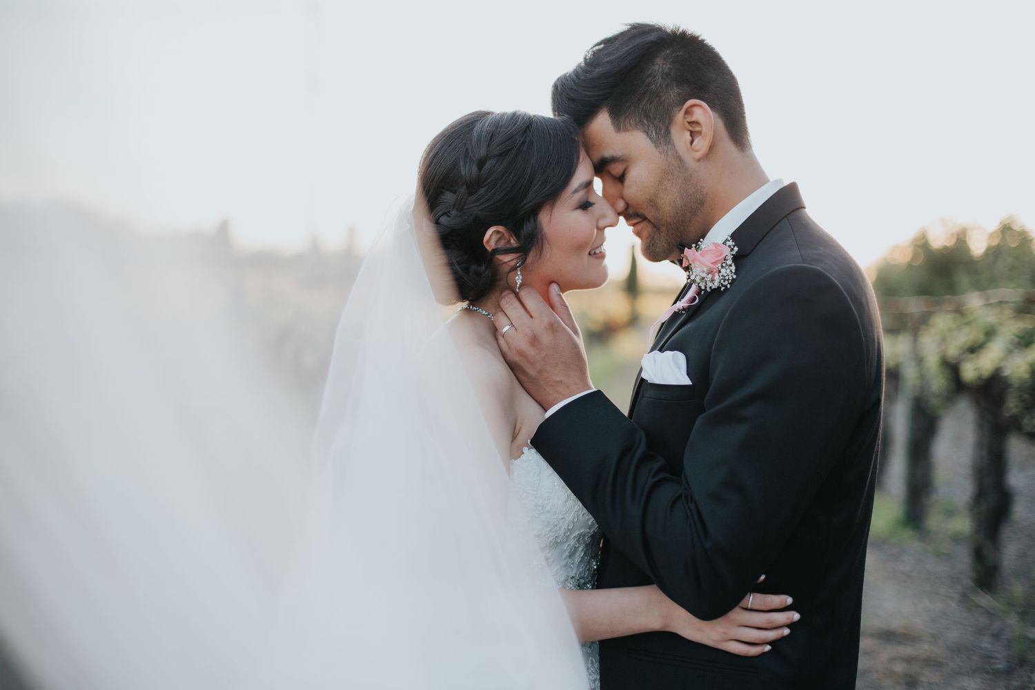 Bride and groom sharing a soft kiss in at Vintners inn, with the bride holding the groom’s face, radiating romance and connection