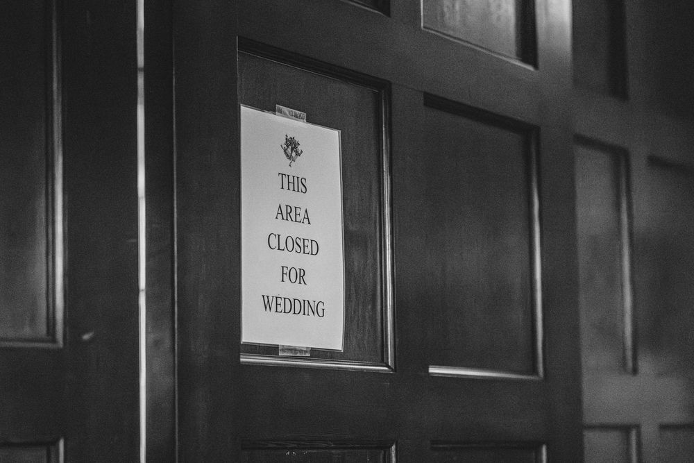 A black and white sign on a door reads 'This Area Closed For Wedding'.