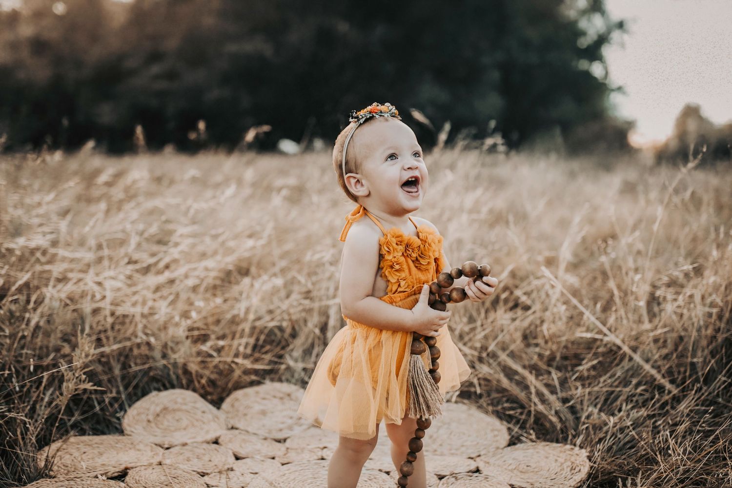 a one year old celebrates her birthday milestone with a photo shoot in a pretty butterscotch tutu