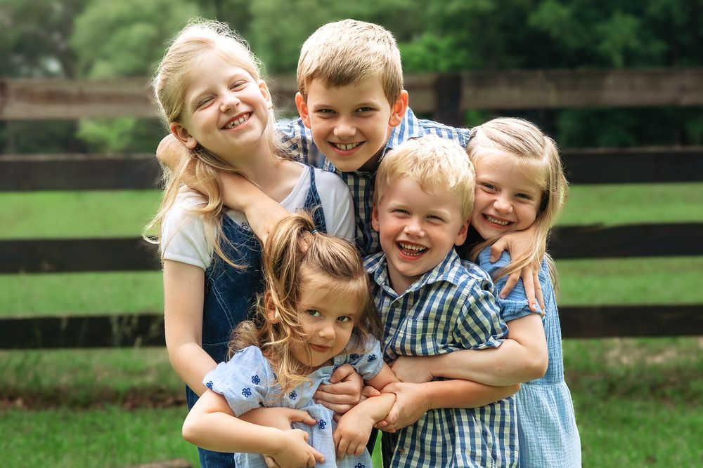 Children from extended family session smiling together during outdoor photoshoot in Athens GA