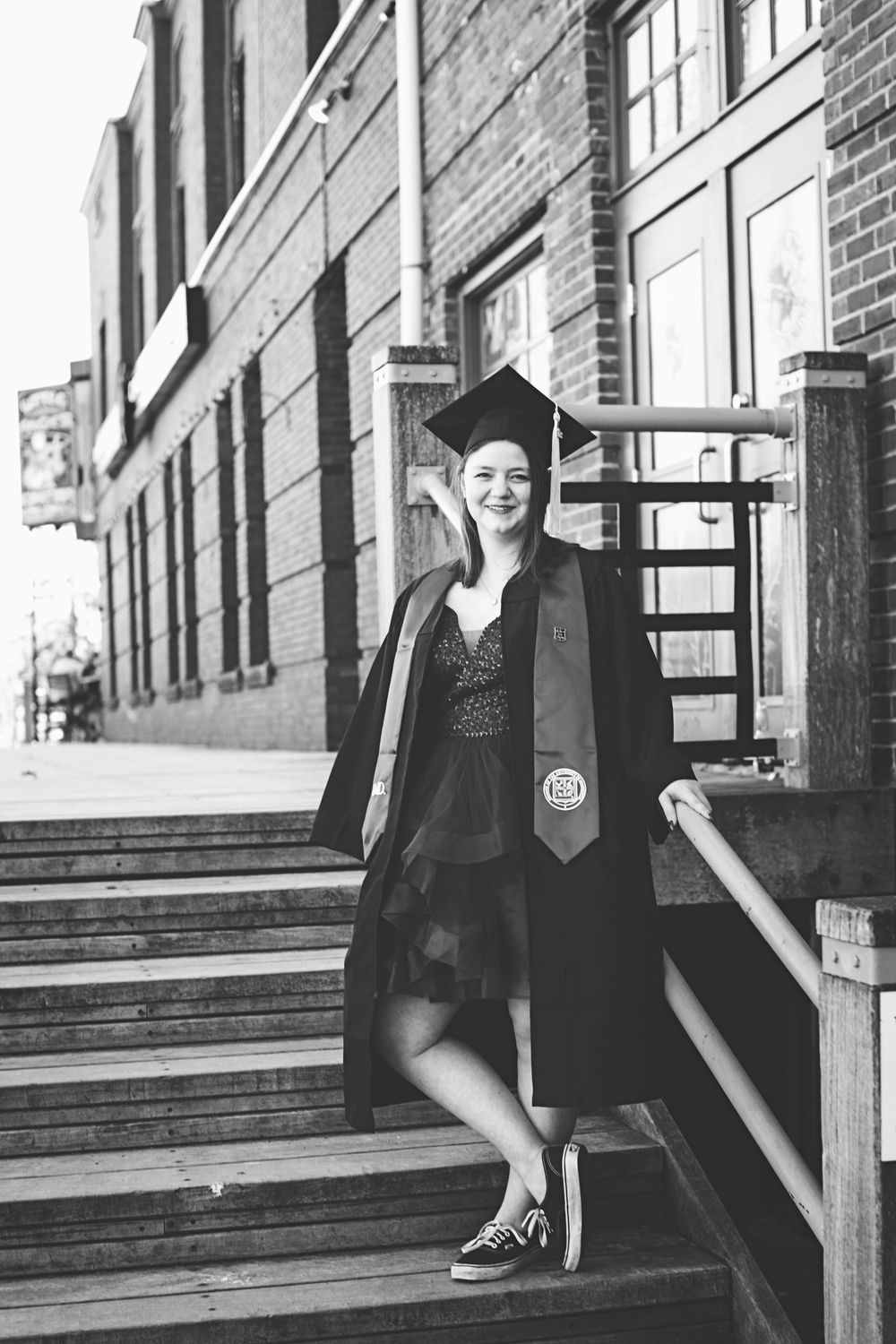 Black and white photos feature a formal portrait series against a rustic wooden backdrop with stairs.