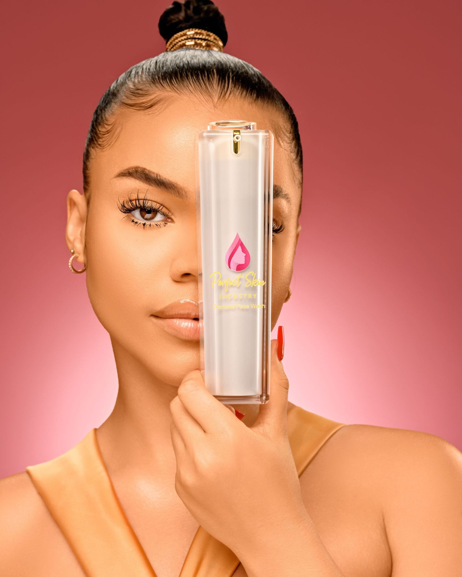 Beauty product photography series showing sleek cosmetic bottles against a pink glowing background.