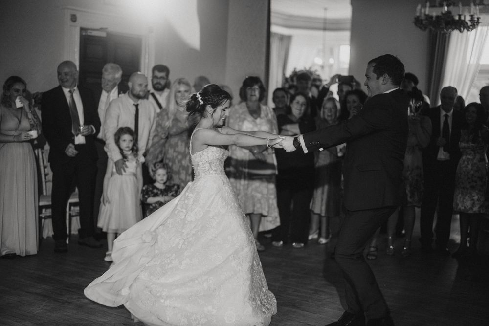 A couple shares their first dance together at a wedding reception while guests look on at Cave Castle - taken by Grimsby photographer.