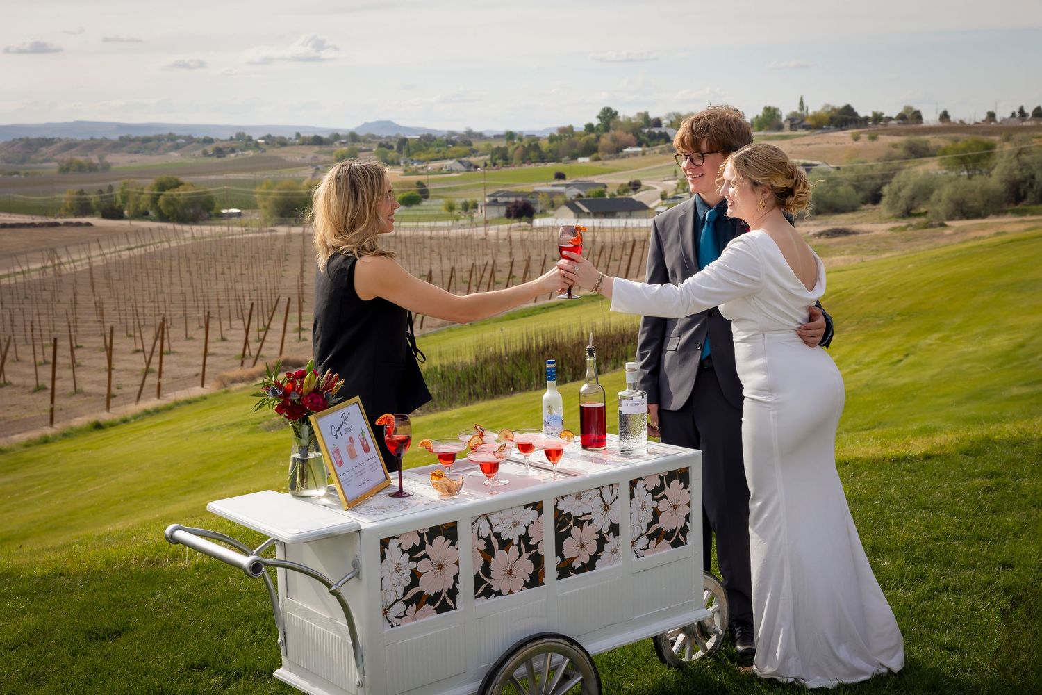 bar tender handing bride and groom a drink with Tilly the Tipsy Trailer at Garman Hill