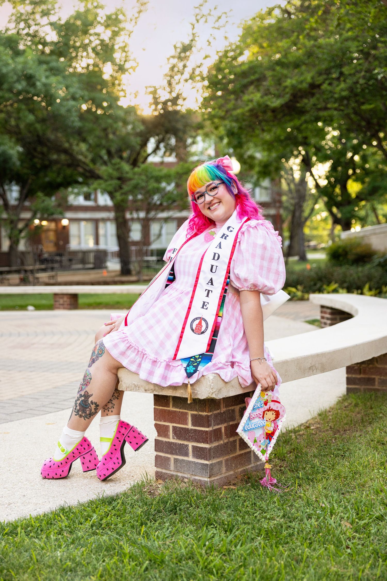 Kawaii street fashion look featuring pink and white gingham dress, polka dot platforms, and colorful accessories in outdoor setting.