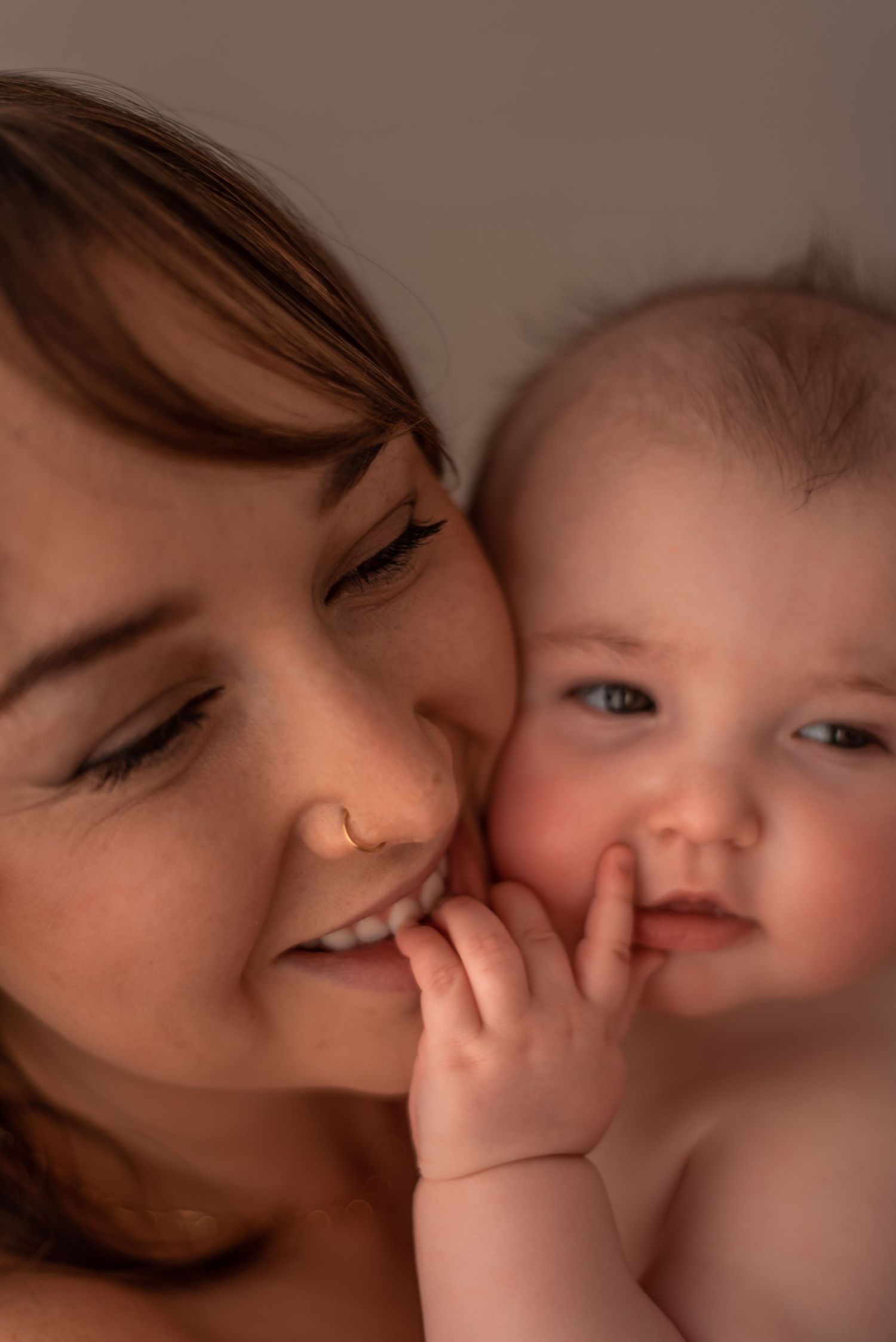 Intimate portrait of a baby and parent sharing a close emotional moment together.