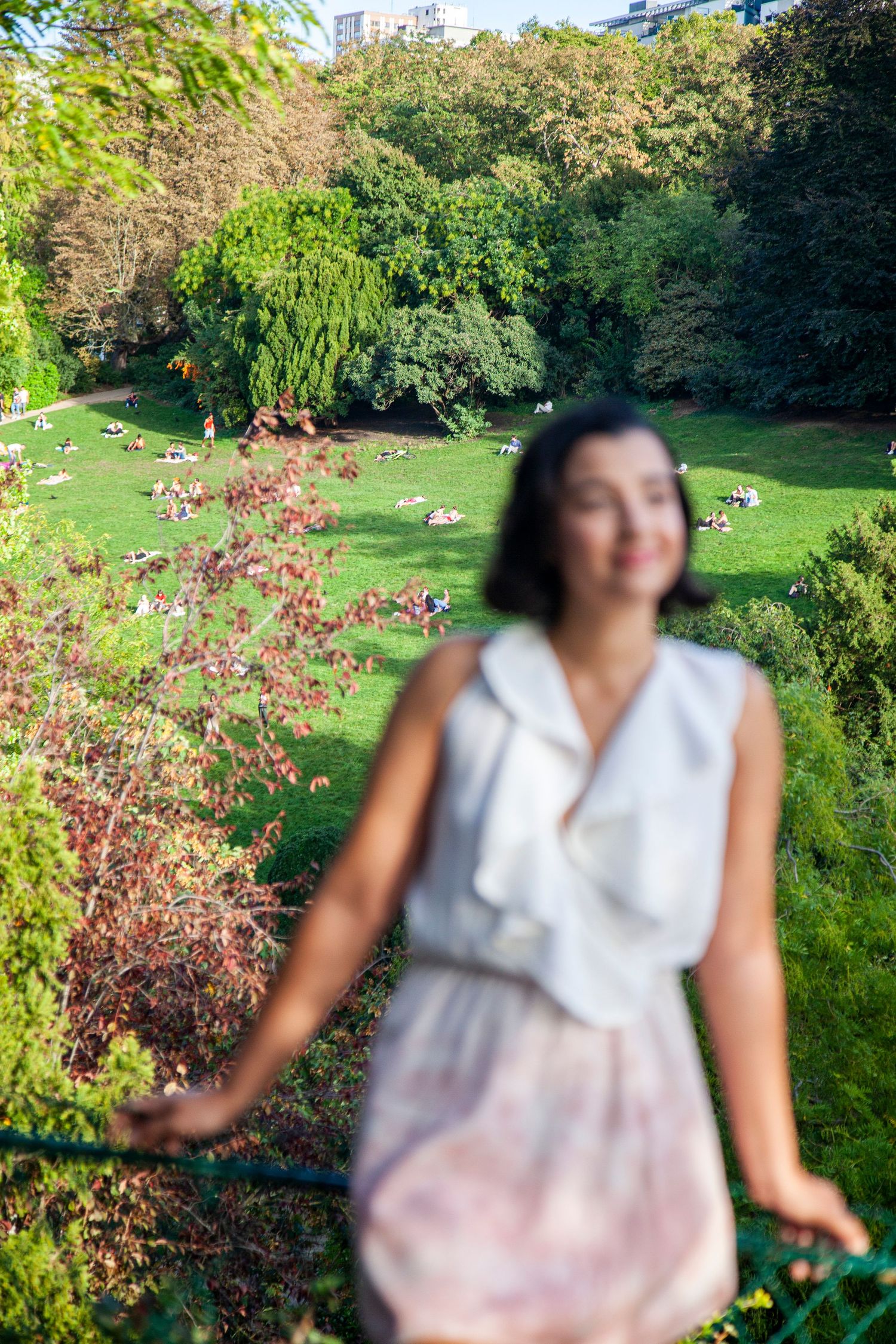 Scenic garden view with flowering plants and lush greenery in an urban park setting.