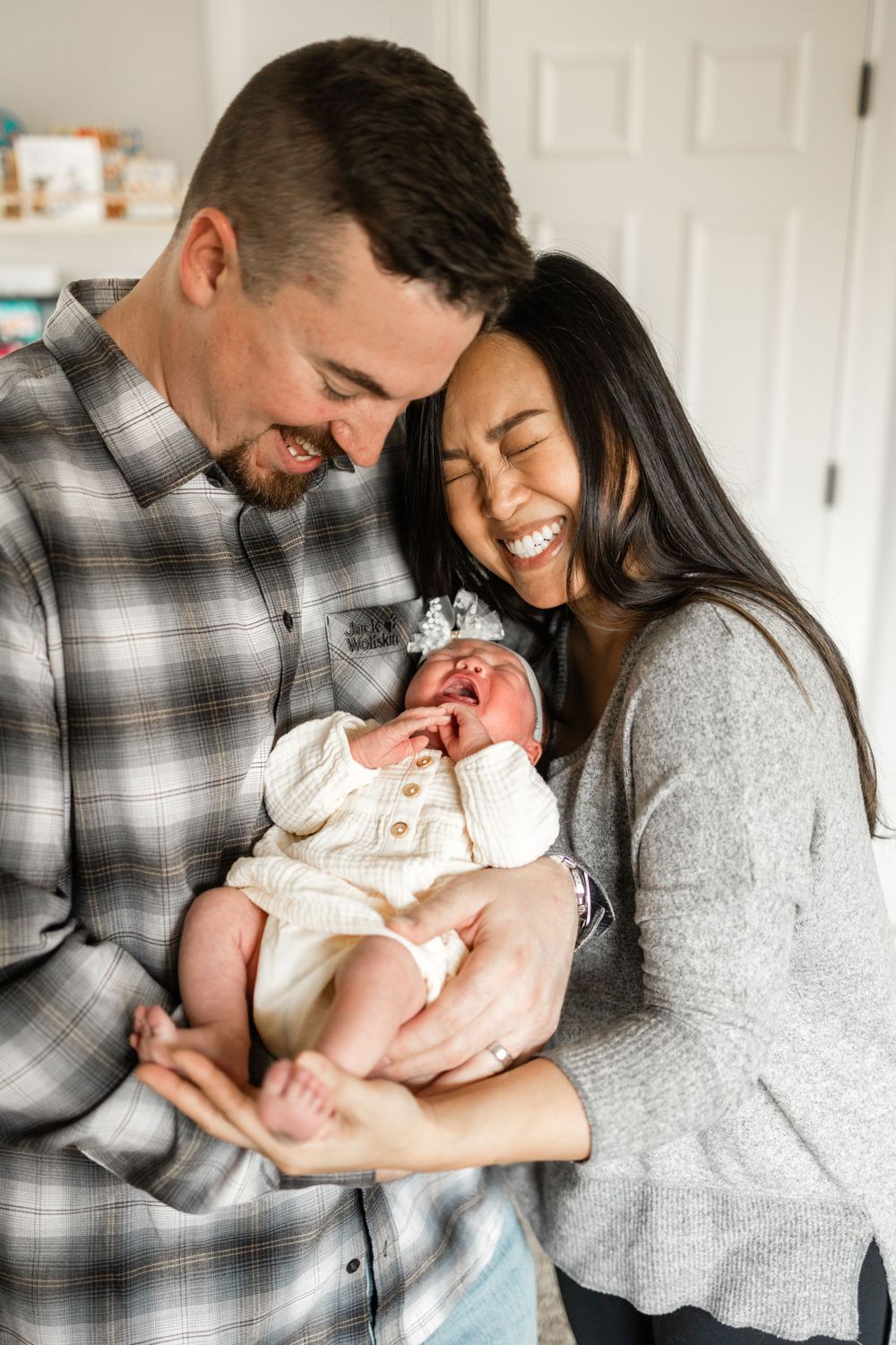 A joyful moment shared between new parents and their baby.