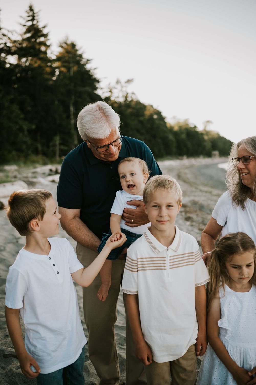 Comox Valley family photoshoot of grandpa with grandkids on Kye Bay Beach. Portraits taken by photographer Soulfull Photographs