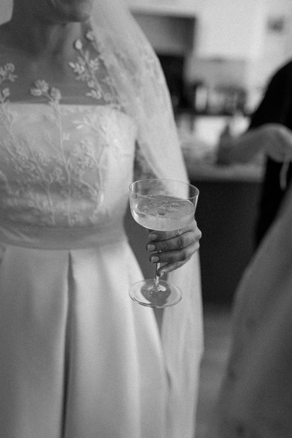 Bride holds a drink before leaving for her London wedding ceremony.