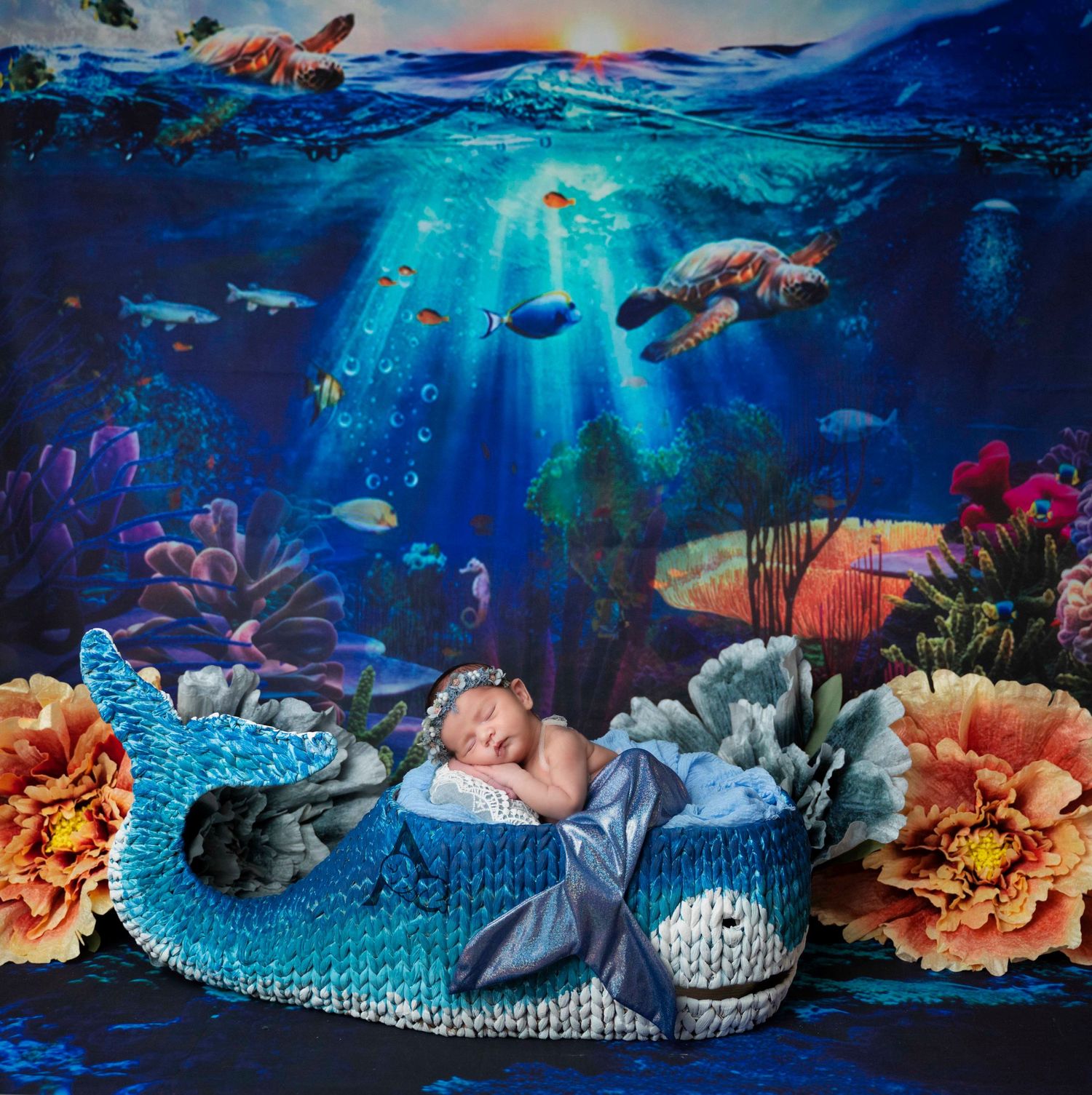 Underwater fantasy newborn photography with sea turtles, coral reefs, and magical blue lighting effects.