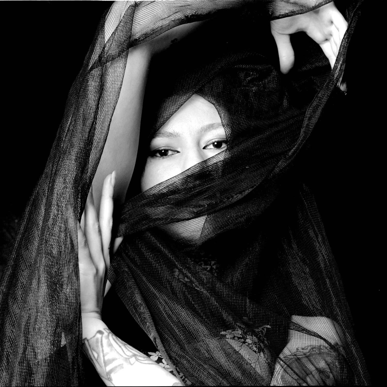 Model Ana Maria Viga shrouded in black fabric