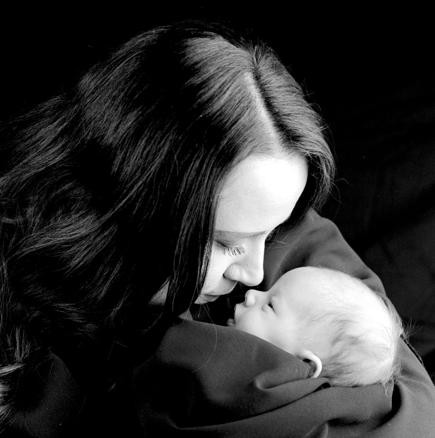 black and white moody portrait of a new mum and her baby