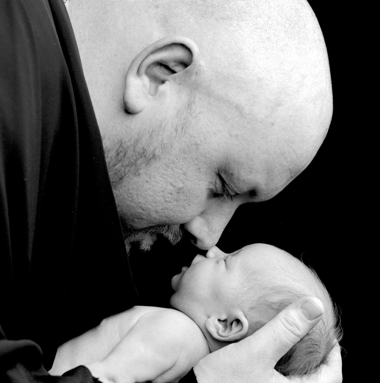 black and white moody portrait of a father and his baby