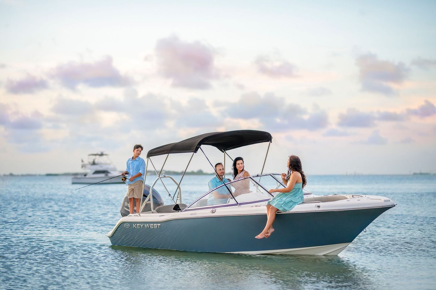 Portrait of family who loves to boat. They sit on the boat on Banana River in Brevard County and enjoy Friday evening together.