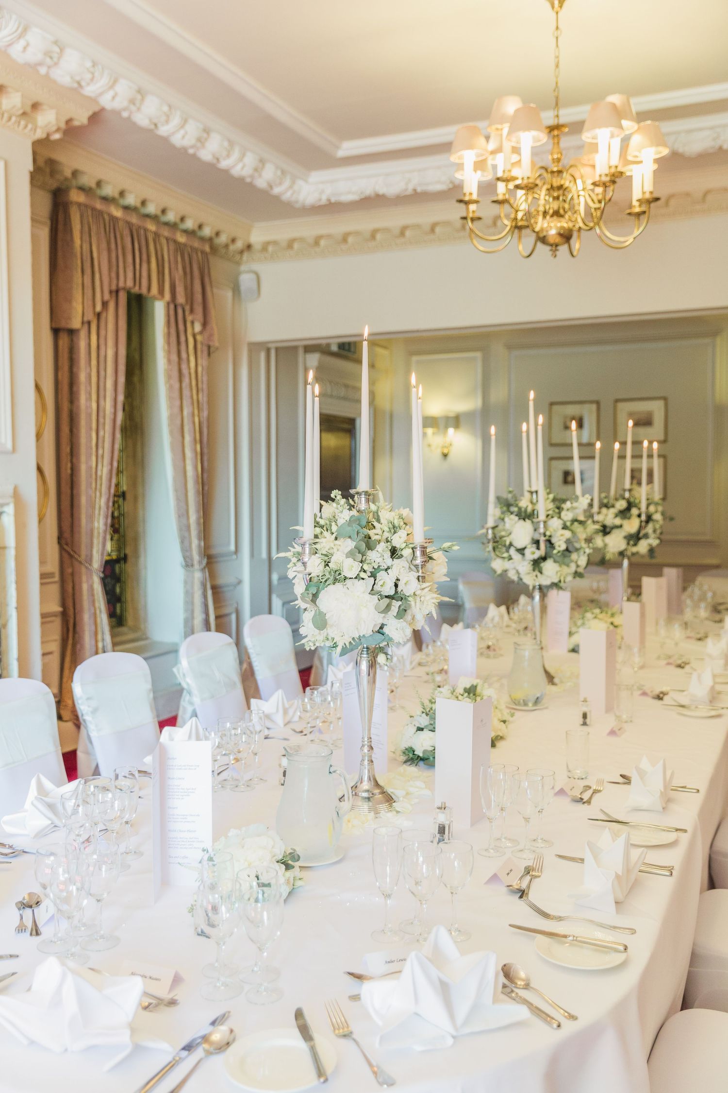 Elegant wedding reception table with white floral centre pieces in luxurious ballroom at Celtic Manor Hayley Elizabeth Photography